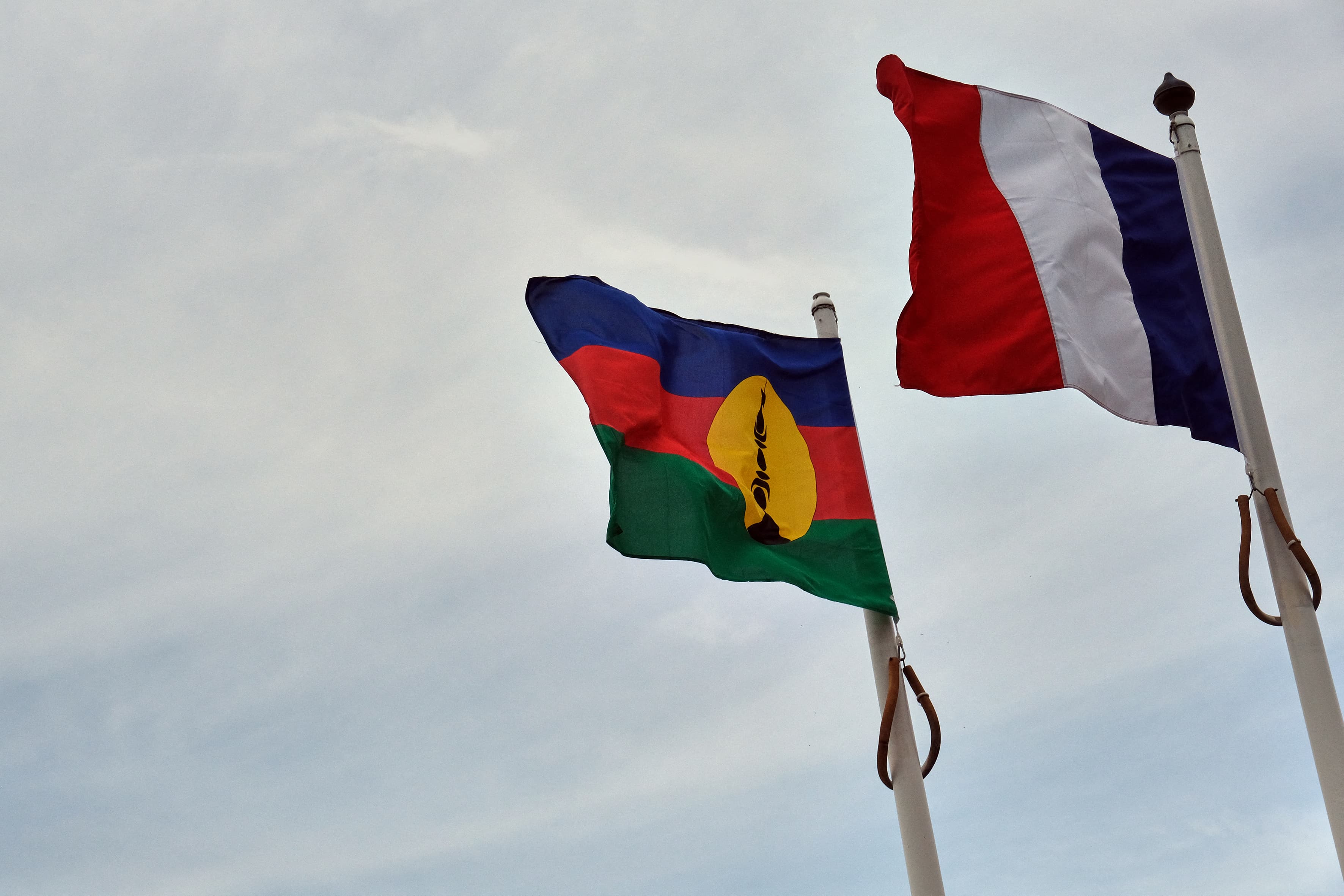 French, right, and Kanak flags.