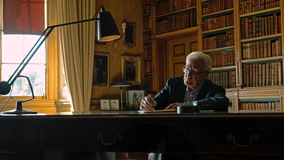 Movie still from the documentary film The Pigeon Tunnel showing the author John Le Carré at a writing desk