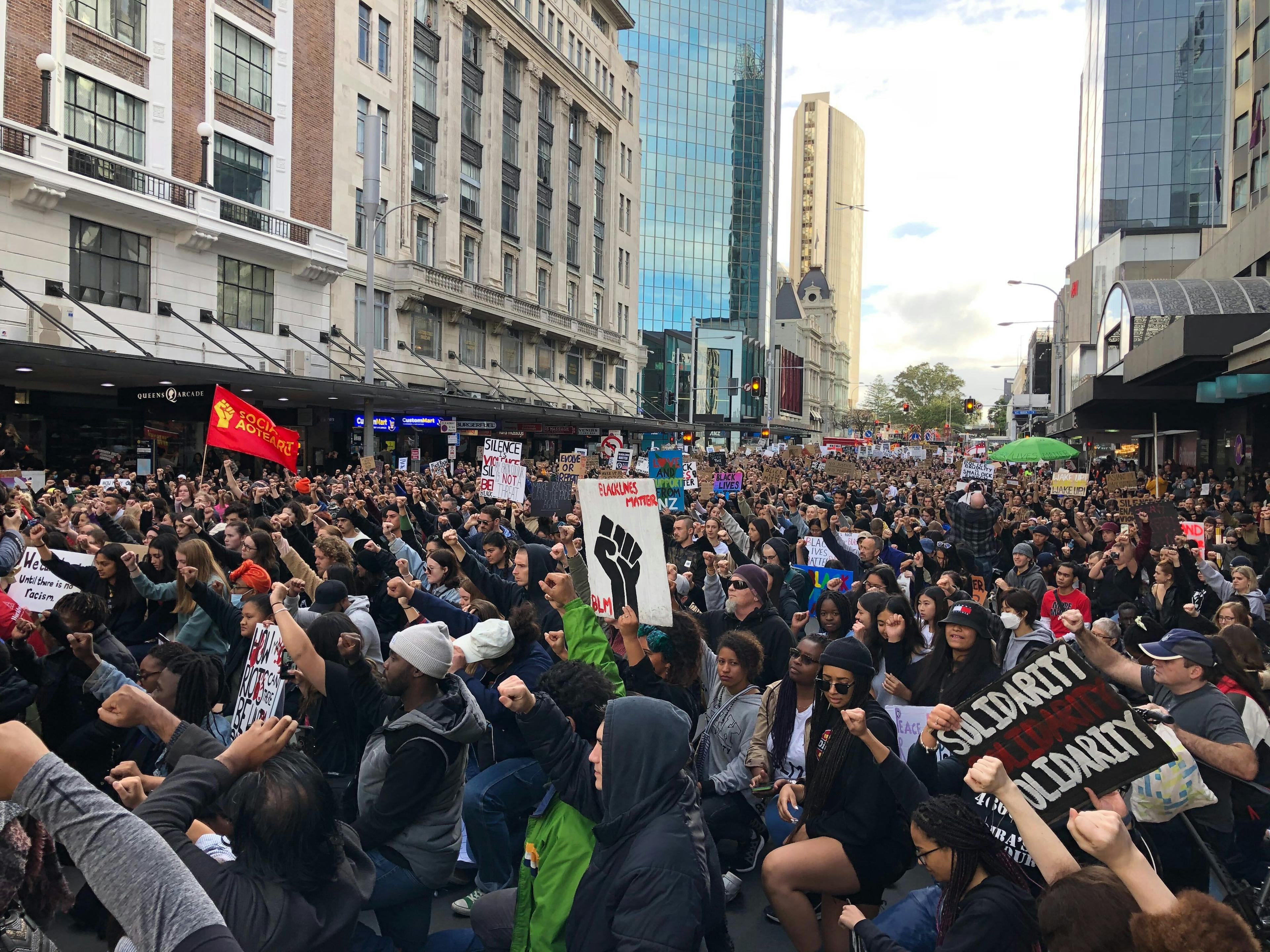 Black Lives matter protesters take a knee outside the US consulate in central Auckland.