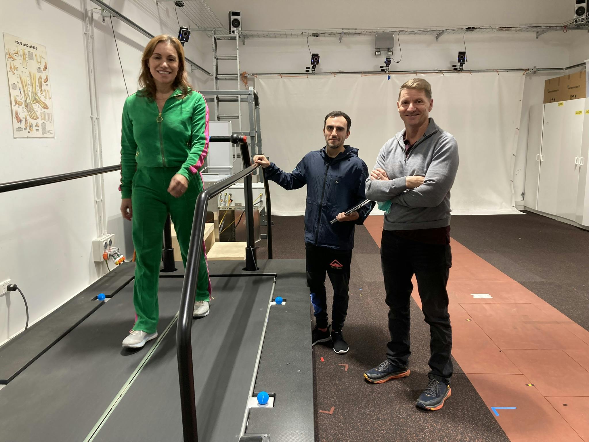 Stacey Morrison on a treadmill at the movement neuroscience laboratory at the University of Auckland with Pablo Ortega Auriol and Professor Winston Byblow.