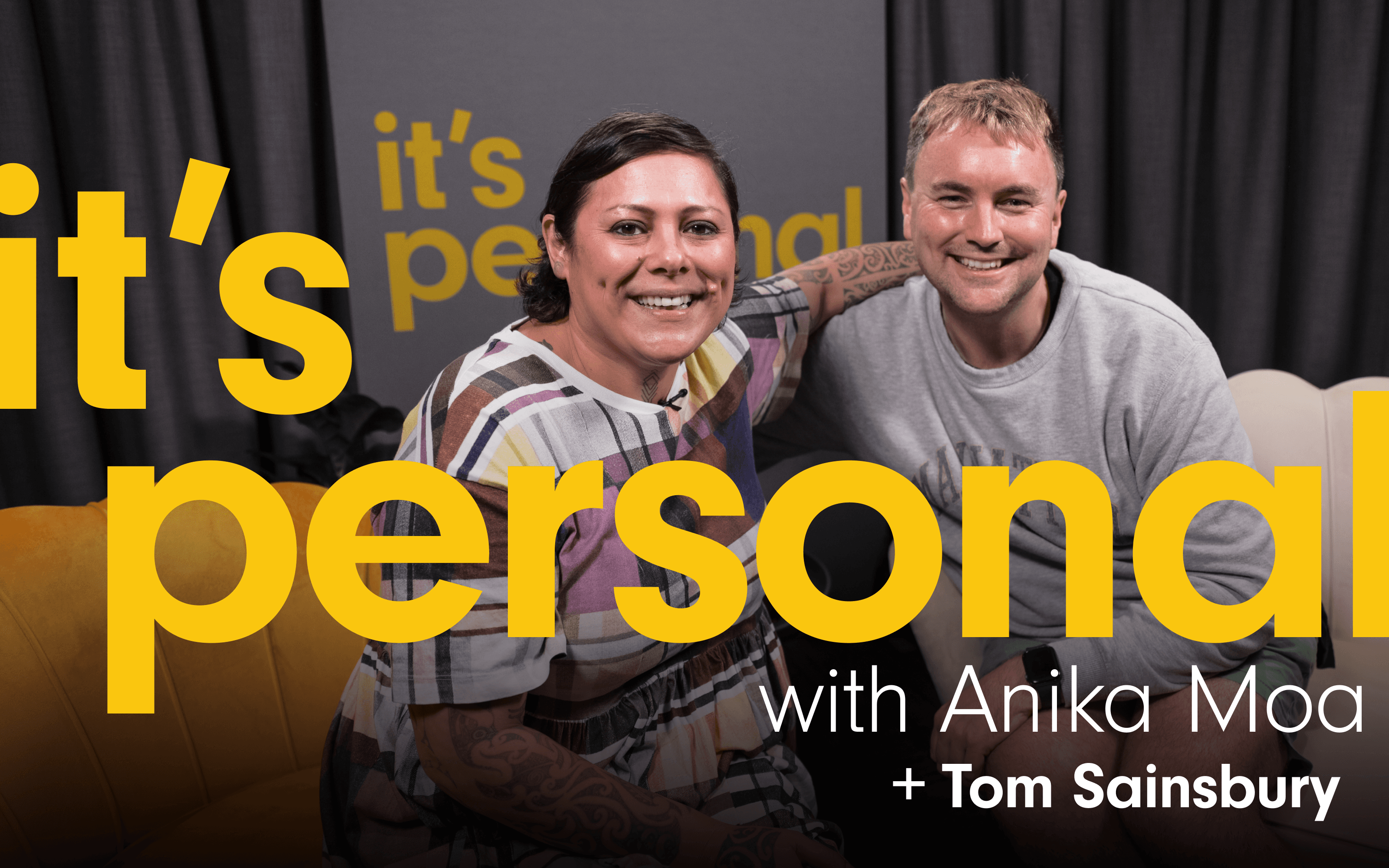 Photo of Anika Moa and guest smiling. They are sitting on the couches where the interview takes place. The podcast title ‘It’s Personal with Anika Moa ’ Is written Plus the guest’s name,