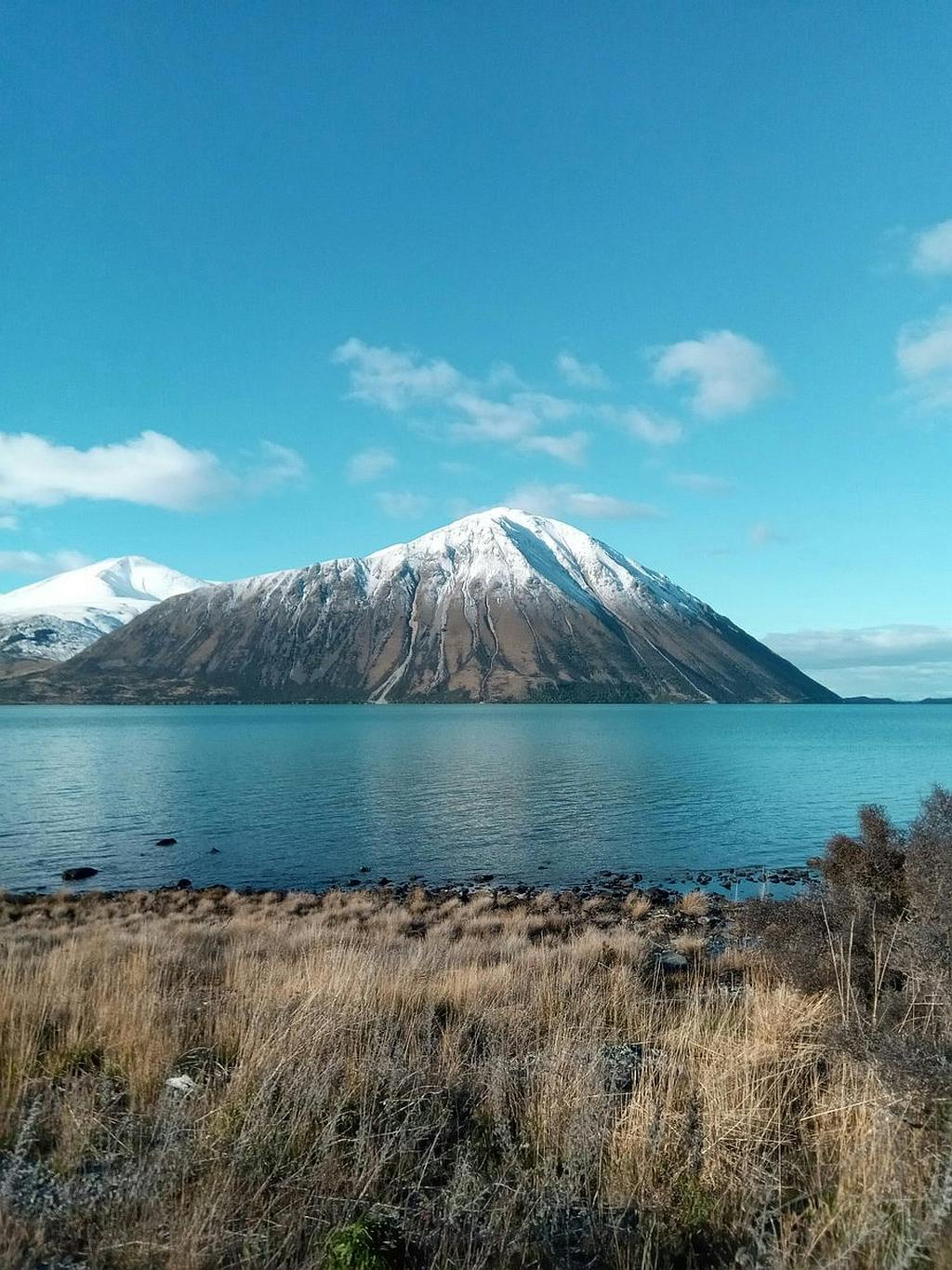 A view across Lake Ohau with a snowy peak in the background.