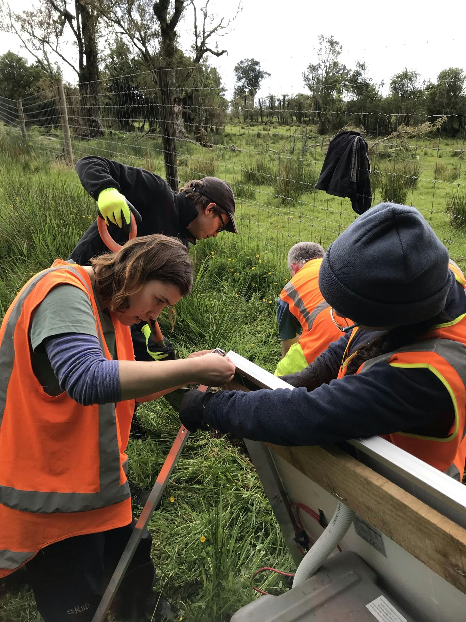 The SALSA team at work. Ash & Olivia build the solar panel while John & Finn start digging.