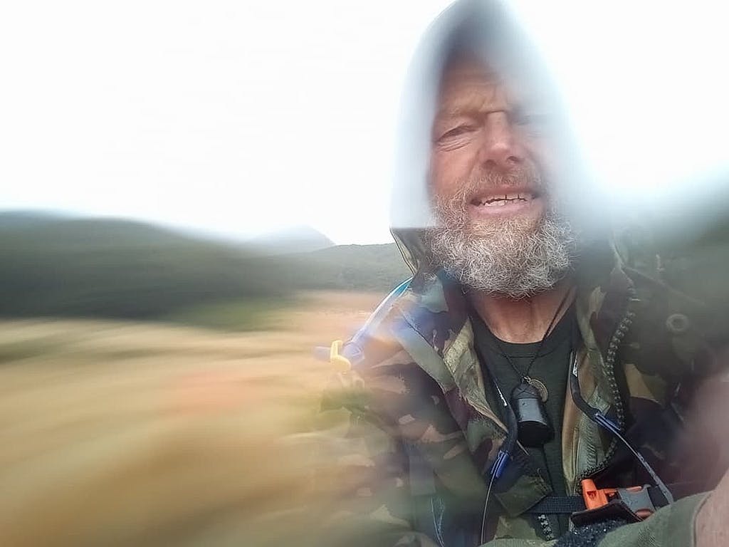 A portrait of Bruce Hopkins in heavy rain in Southland.