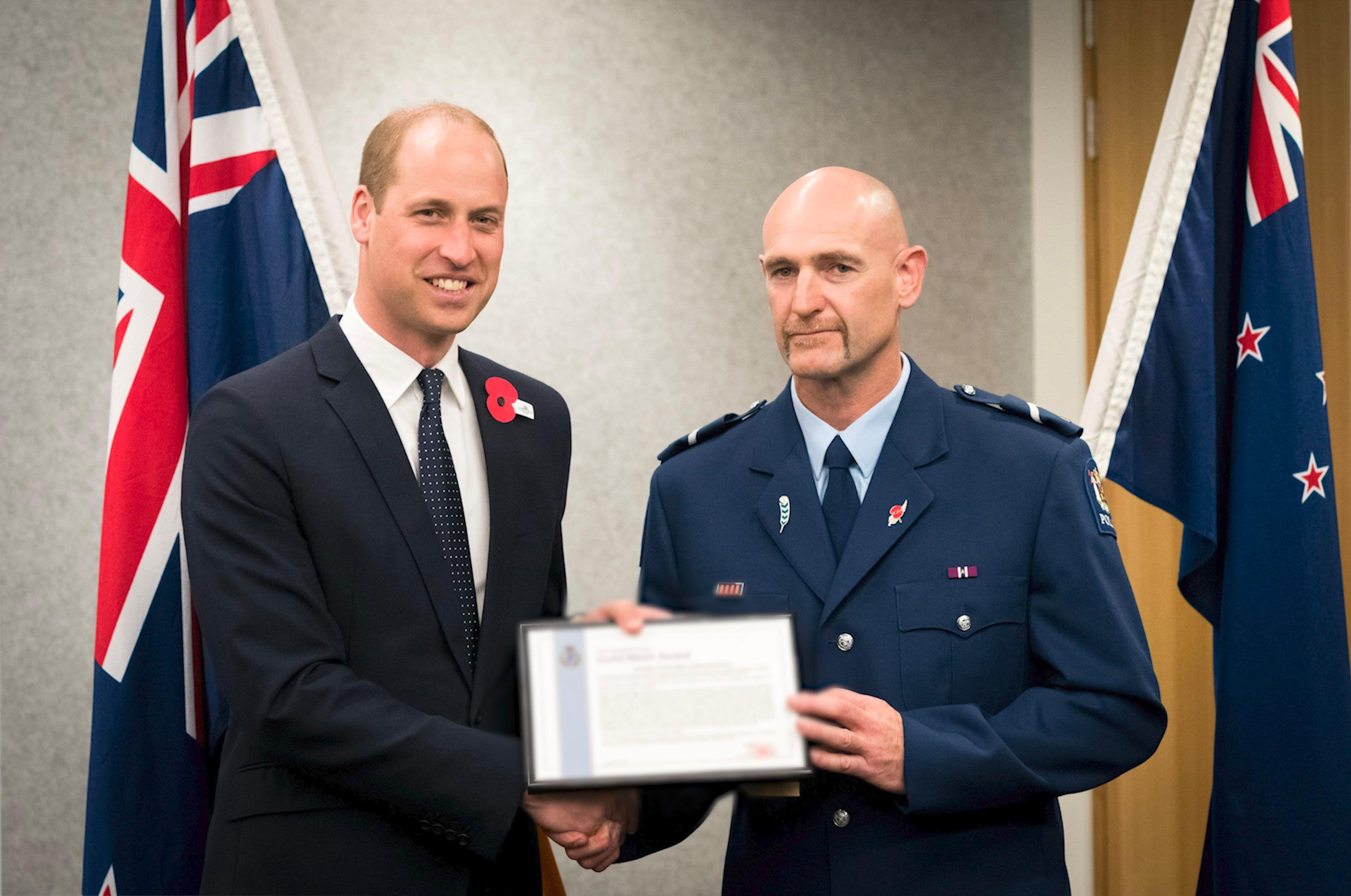 Senior Constable Scott Carmody receiving an award from Prince William.