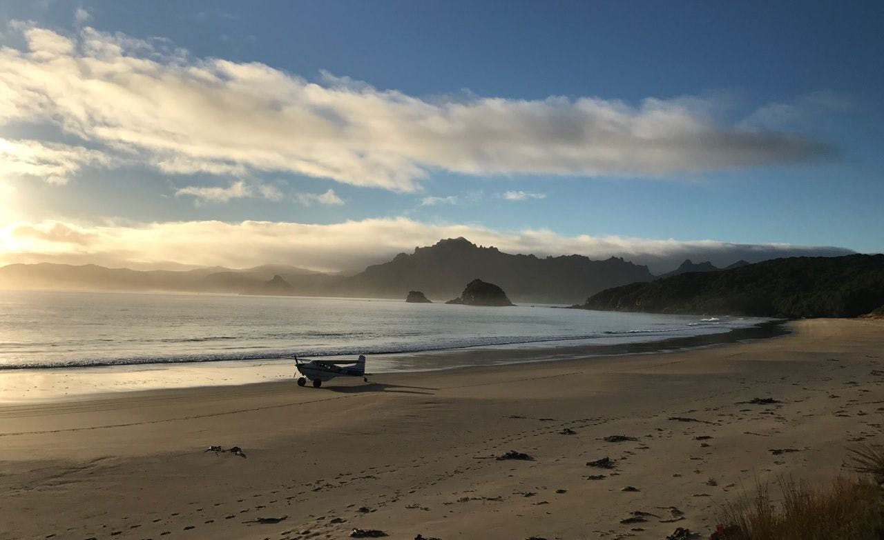 JEM the Cessna has been ferrying passengers and equipment for Whenua Hou / Codfish Island for 26 years. Stewart Island's Ruggedy Range is in the background.