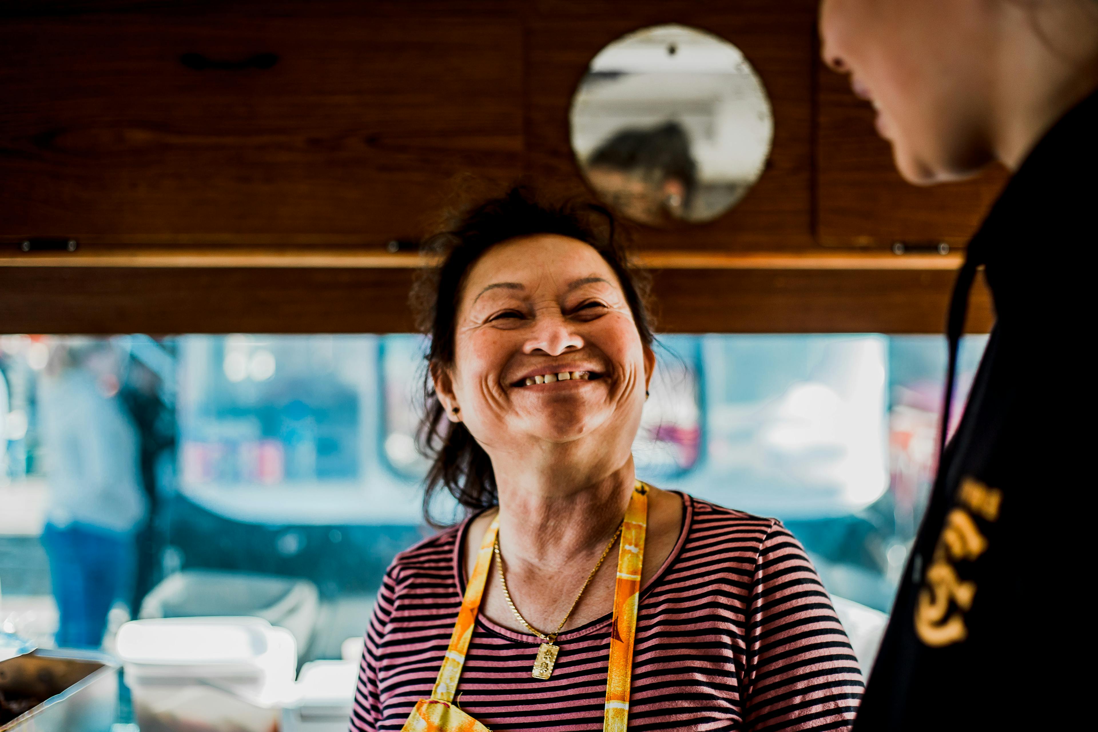 (L-R) Mom Meng glances up at her granddaughter Emrie Meng in her food truck in Lower Hutt, Wellington.