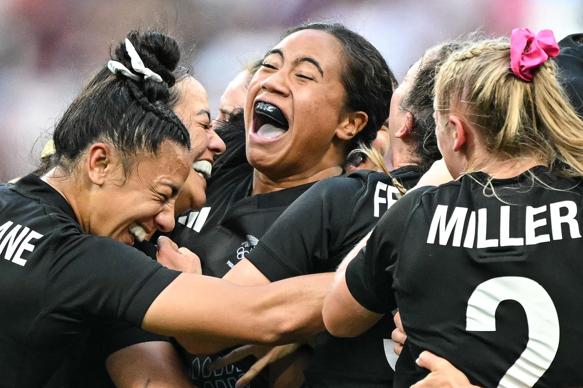 New Zealand's players celebrate after the women's gold medal rugby sevens match between New Zealand and Canada during the Paris 2024 Olympic Games at the Stade de France in Saint-Denis on July 30, 2024. (Photo by CARL DE SOUZA / AFP)