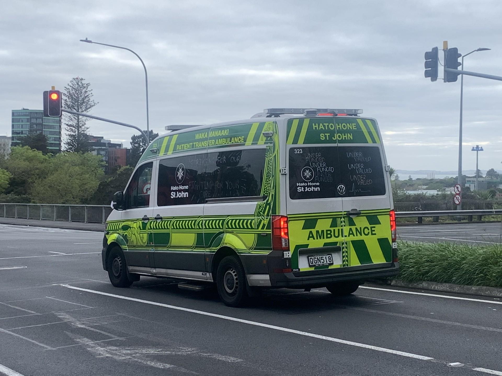 A St John ambulance with messages of strike action written on the windows