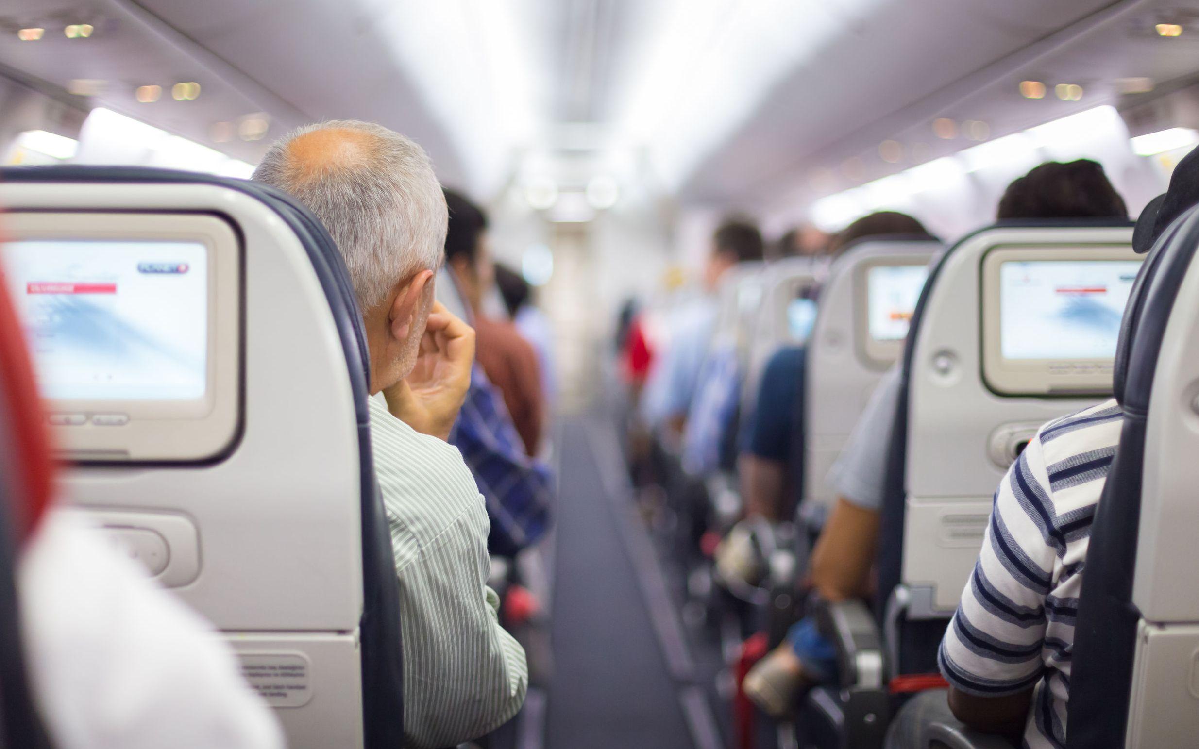 37072008 - interior of airplane with passengers on seats waiting to taik off.