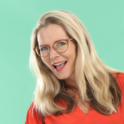 Image of Suzy Cato smiling in front of a mint green background.