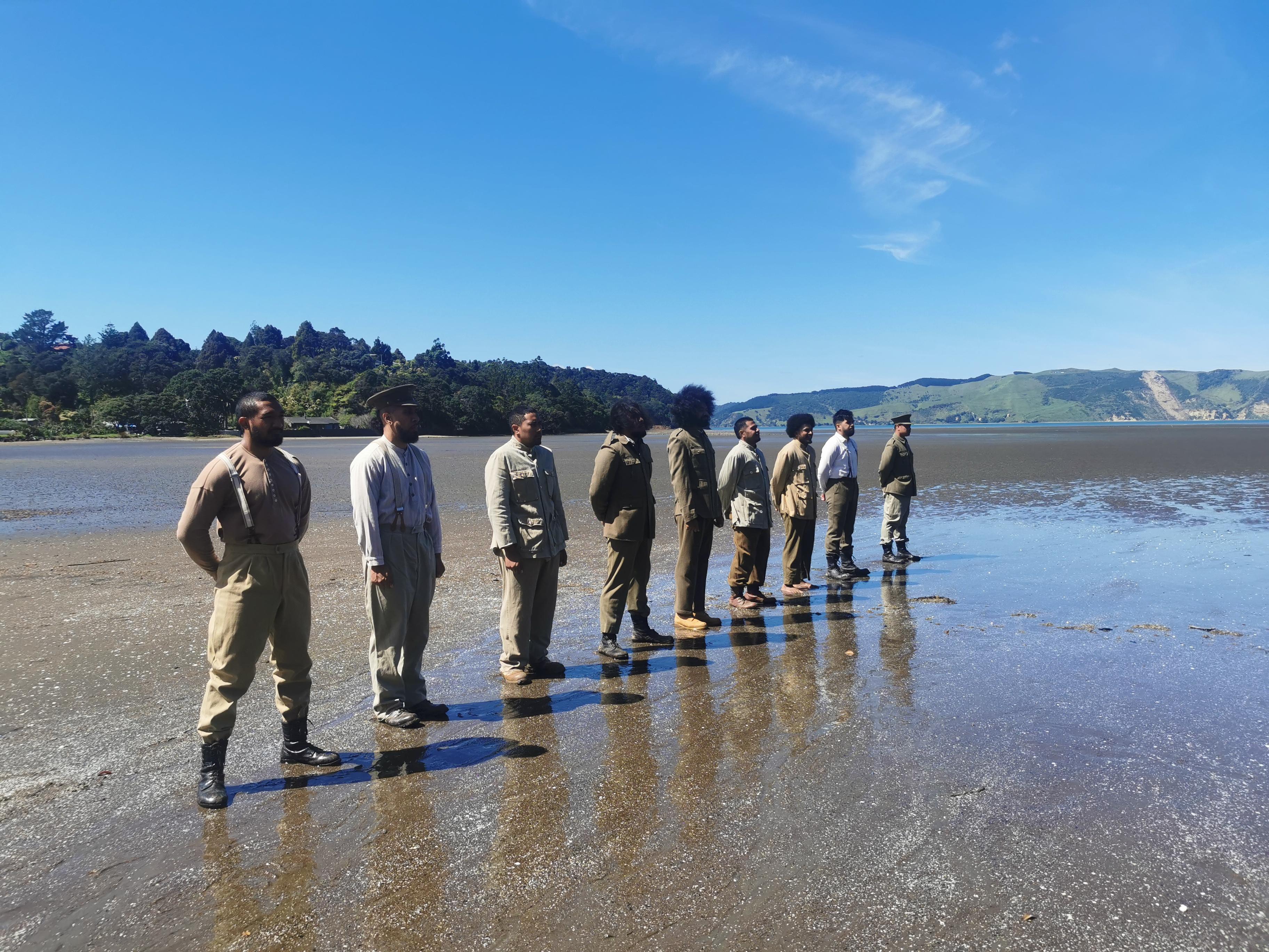 Soldiers stand at attention (dramatic re-enactment).