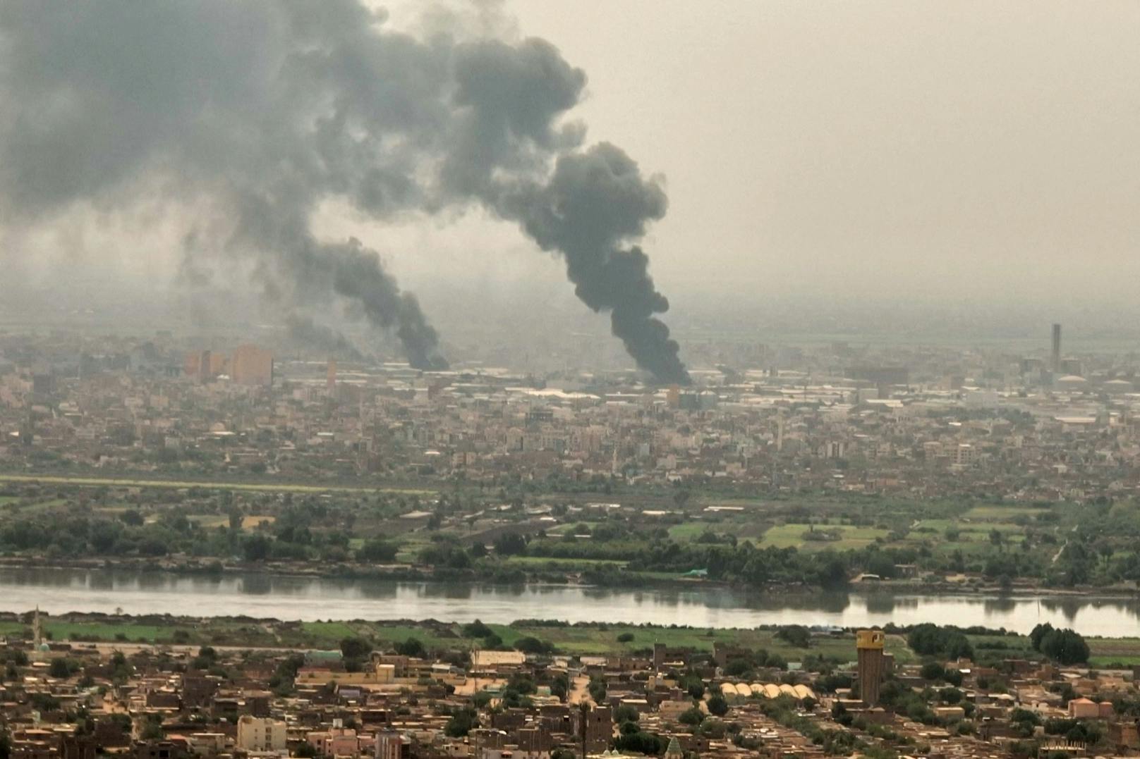 An image grab taken from AFPTV video footage on 28 April, 2023, shows black smoke rising over Sudan's capital Khartoum. Foreign nations scrambled to organise mass evacuations of their citizens as the fighting continued, with Turkey's defence ministry reporting one of its military transport aircraft had come under fire.