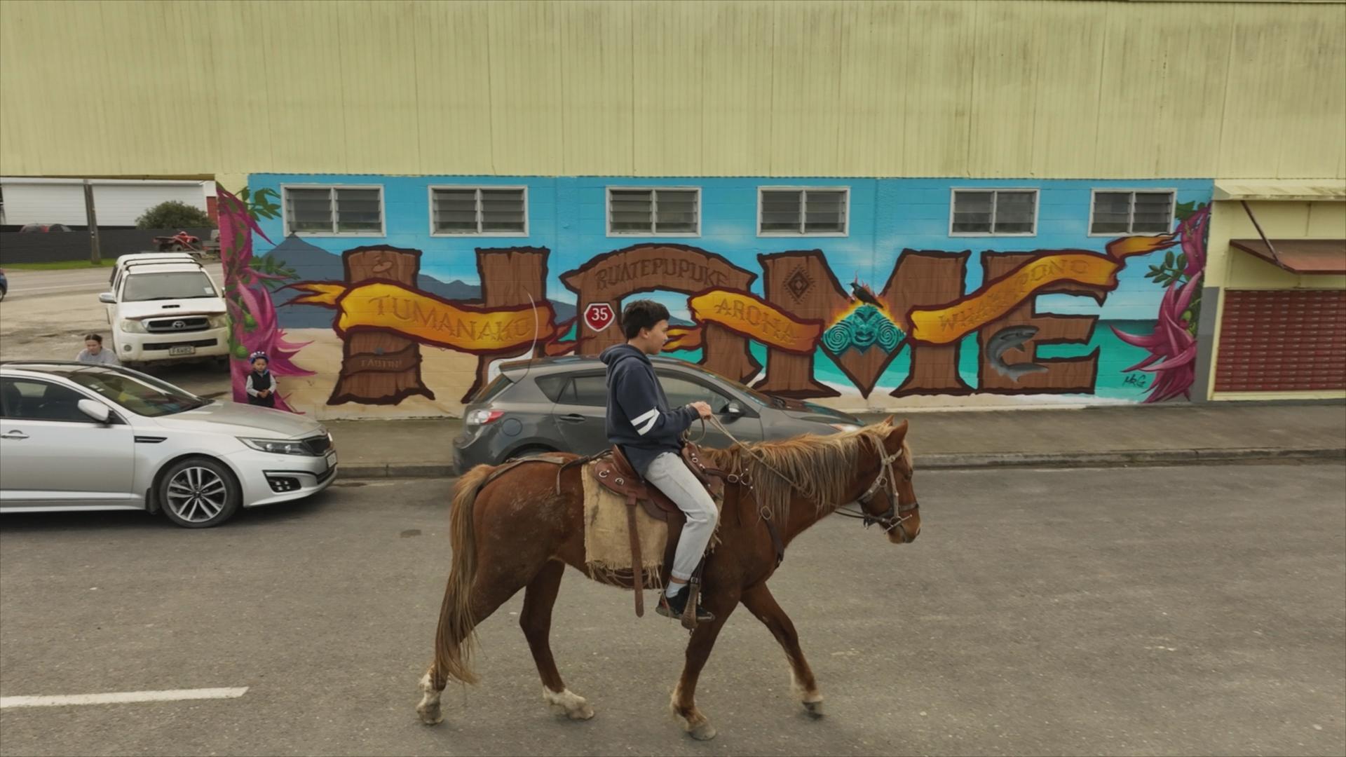 Boy rides horse in Ikaroa-Rāwhiti