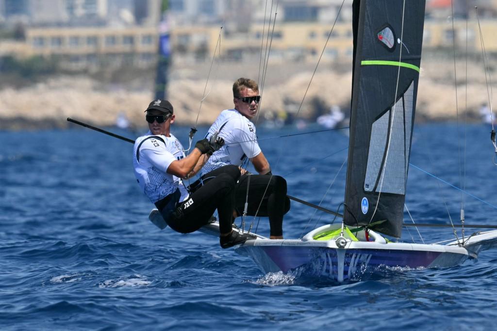 New Zealand's Isaac Mchardie and New Zealand's William Mckenzie compete in Race 1 of the men’s 49er skiff event during the Paris 2024 Olympic Games sailing competition at the Roucas-Blanc Marina in Marseille on July 28, 2024. (Photo by NICOLAS TUCAT / AFP)