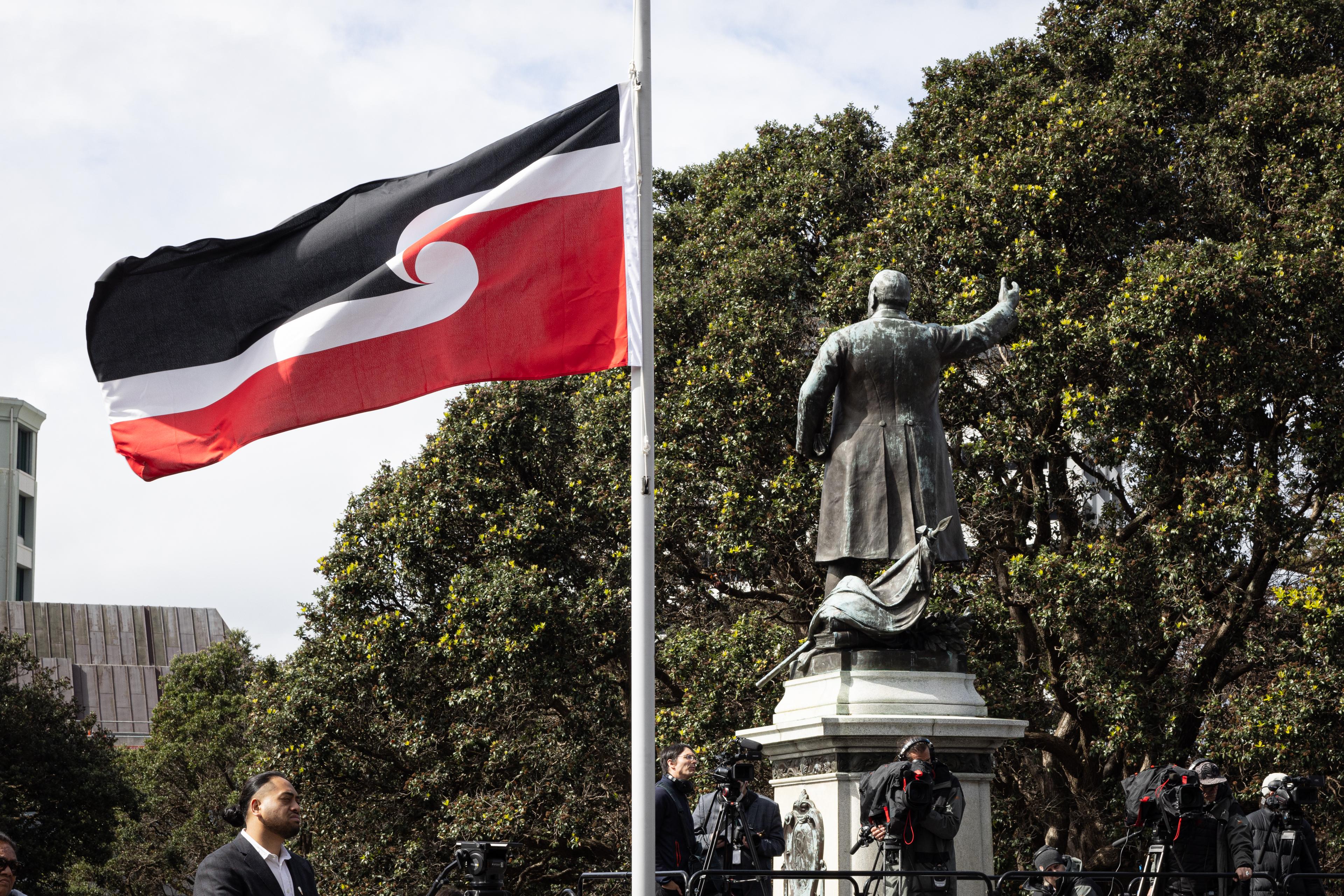 The Tino Rangatiratanga flag flies at Parliament next to the statue of early Premier Dick Seddon. The event was on 14 September 2022 to mark the 50th anniversary of the Māori language petition.