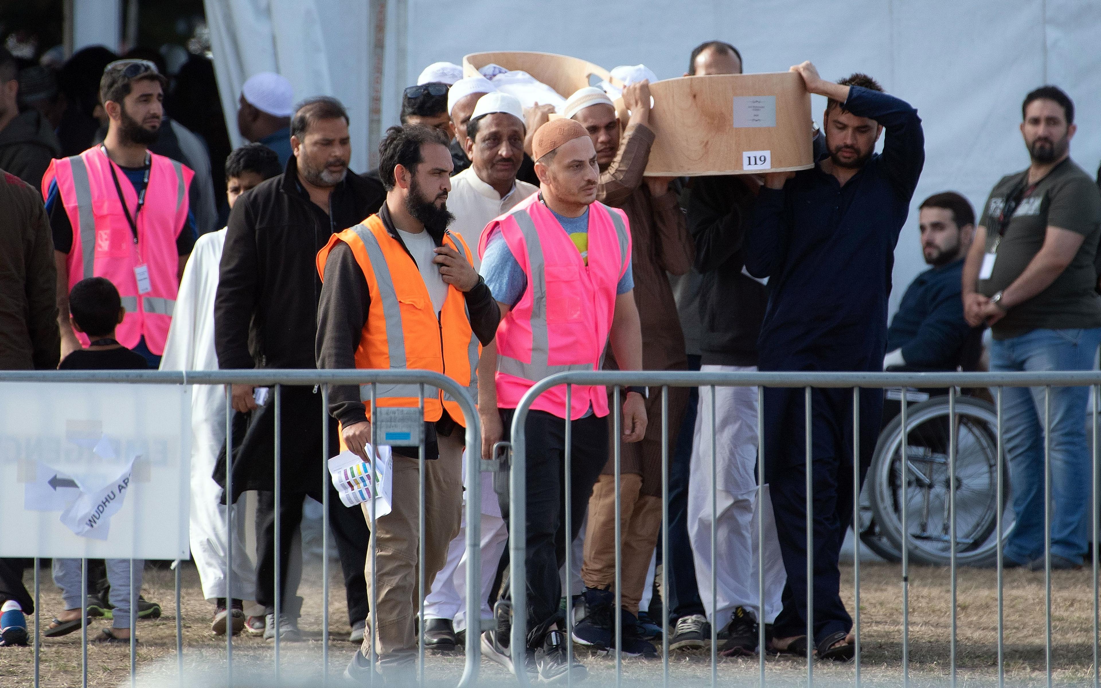 Mourners carry with a coffin containing a victim of the mosque attacks for burial after a funeral prayer at the Memorial Park Cemetery in Christchurch.