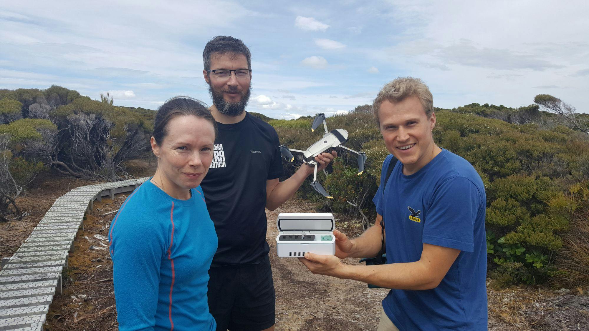 Flying kakapo sperm - a world first. DOC's Kakapo Recovery Team manager Deidre Vercoe with 'spermcopter' drone pilot Anton Marsden, and sperm expert Andreas Bublat holding a tiny vial of kakapo sperm.