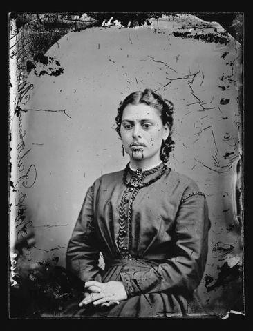 Head and shoulders studio portrait of a Maori woman with moko. c1871.