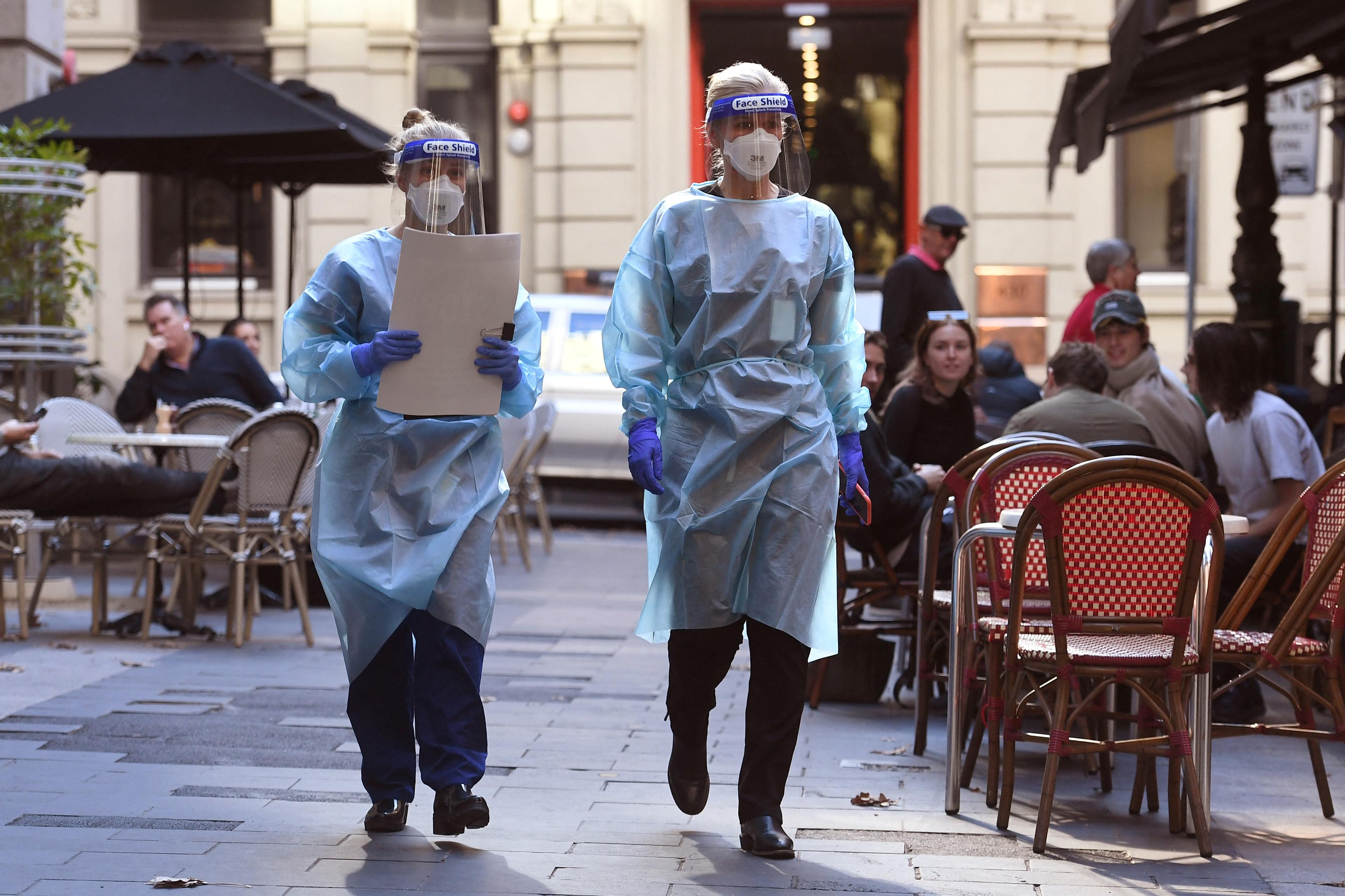 Health department officials arrive to inspect a restaurant and bar in Melbourne on May 12, 2021.