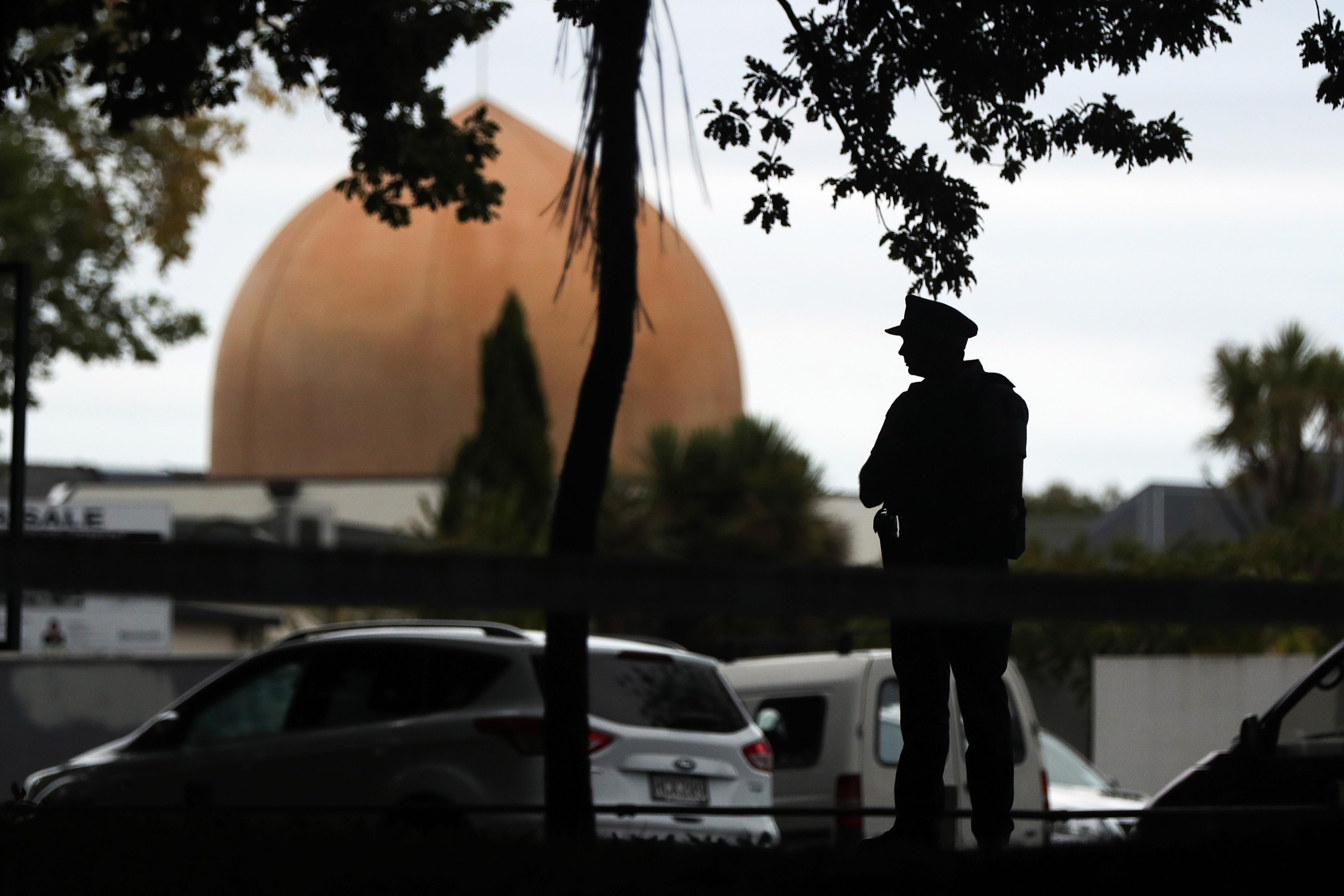 An armed policeman stands guard in front of the Masjid Al Noor Mosque in Christchurch on March 16, 2019. (Photo by MICHAEL BRADLEY / AFP)