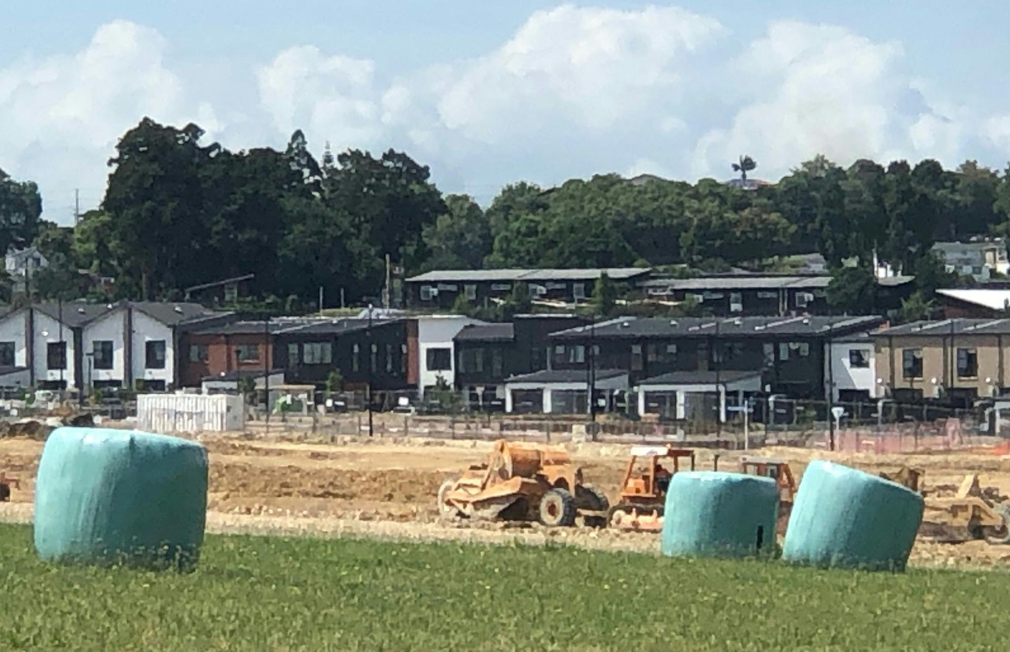 Hay bales in the foreground tell you what this housing development used to look like.