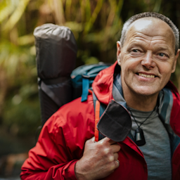 A portrait of a clean-shaven and smiling Bruce Hopkins before starting to walk Te Araroa.