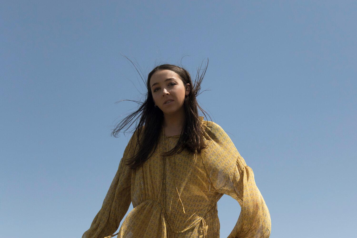 Young woman in a billowy yellow dress