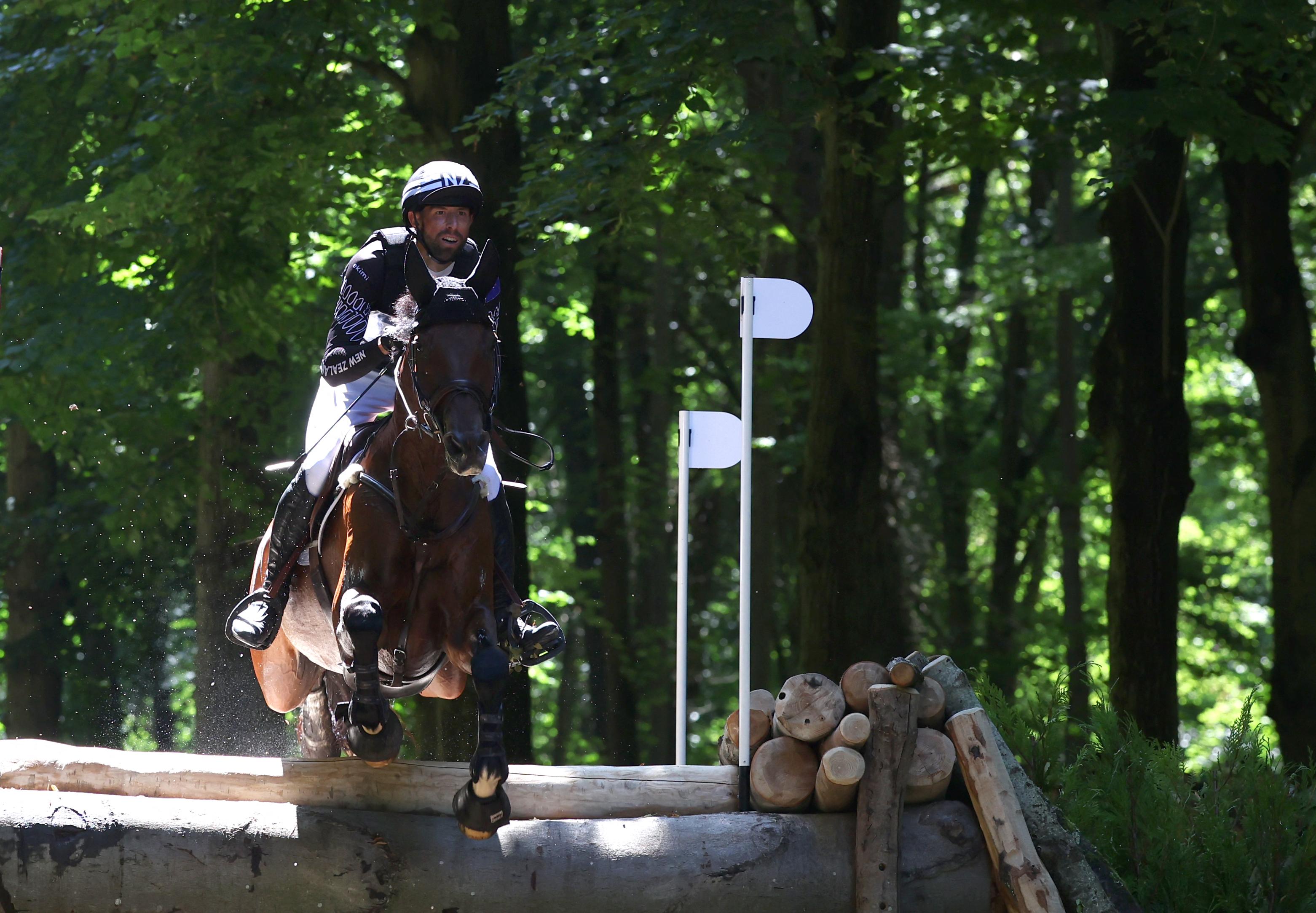 New Zealand's Clarke Johnstone with horse Menlo Park competes in the equestrian's eventing cross country during the Paris 2024 Olympic Games at the Chateau de Versailles, in Versailles, in the western outskirts of Paris, on July 28, 2024. (Photo by Pierre-Philippe MARCOU / AFP)