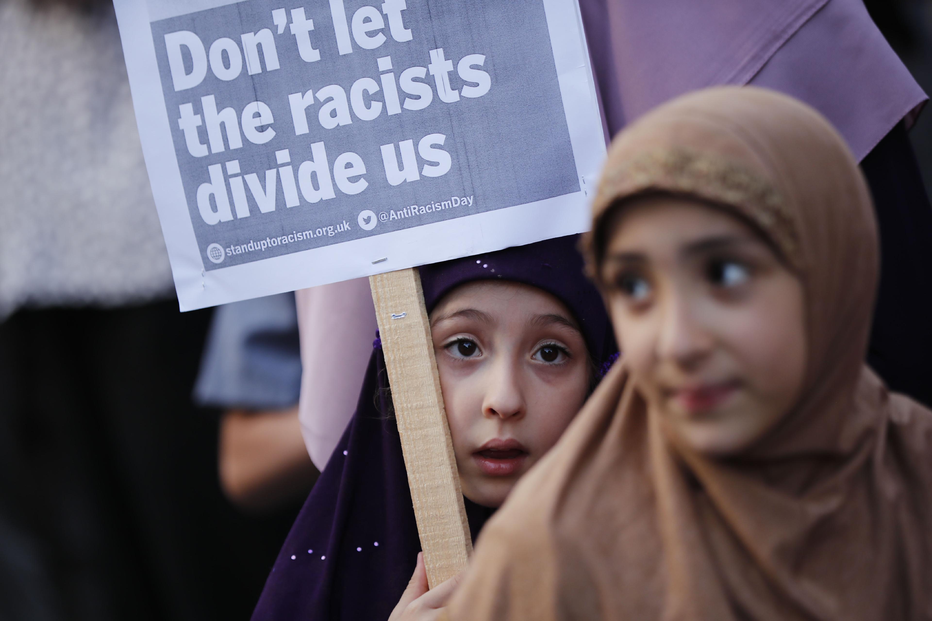 Children attend a vigil outside Finsbury Park Mosque in north London on June 20, 2017, following a van attack on pedestrians nearby on June 19.(Photo by Tolga AKMEN / AFP)