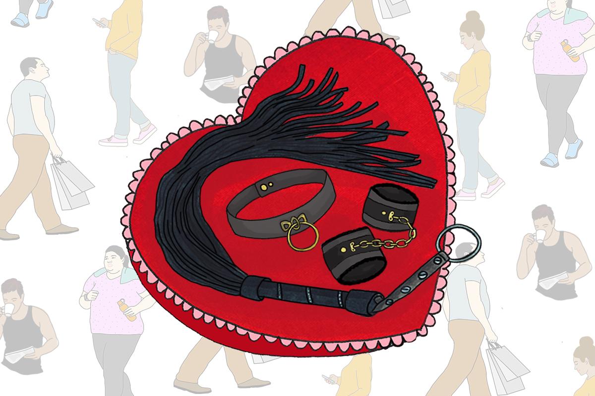 A whip, handcuffs and choker sit on a heart-shaped pillow. In the background, people go about their everyday lives - representing how you can't tell what someone's into just by looking at them.