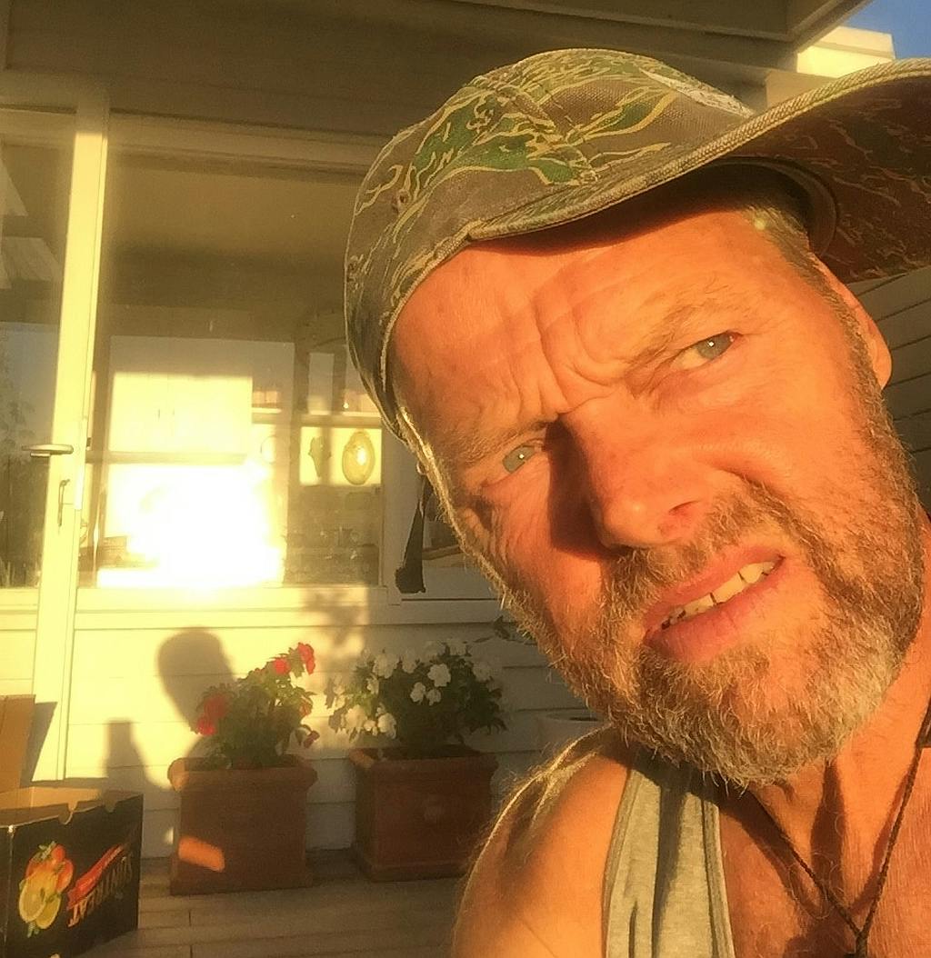 A portrait of Bruce Hopkins at home in Auckland, staring into the sun and wondering when he will get back on the trail.