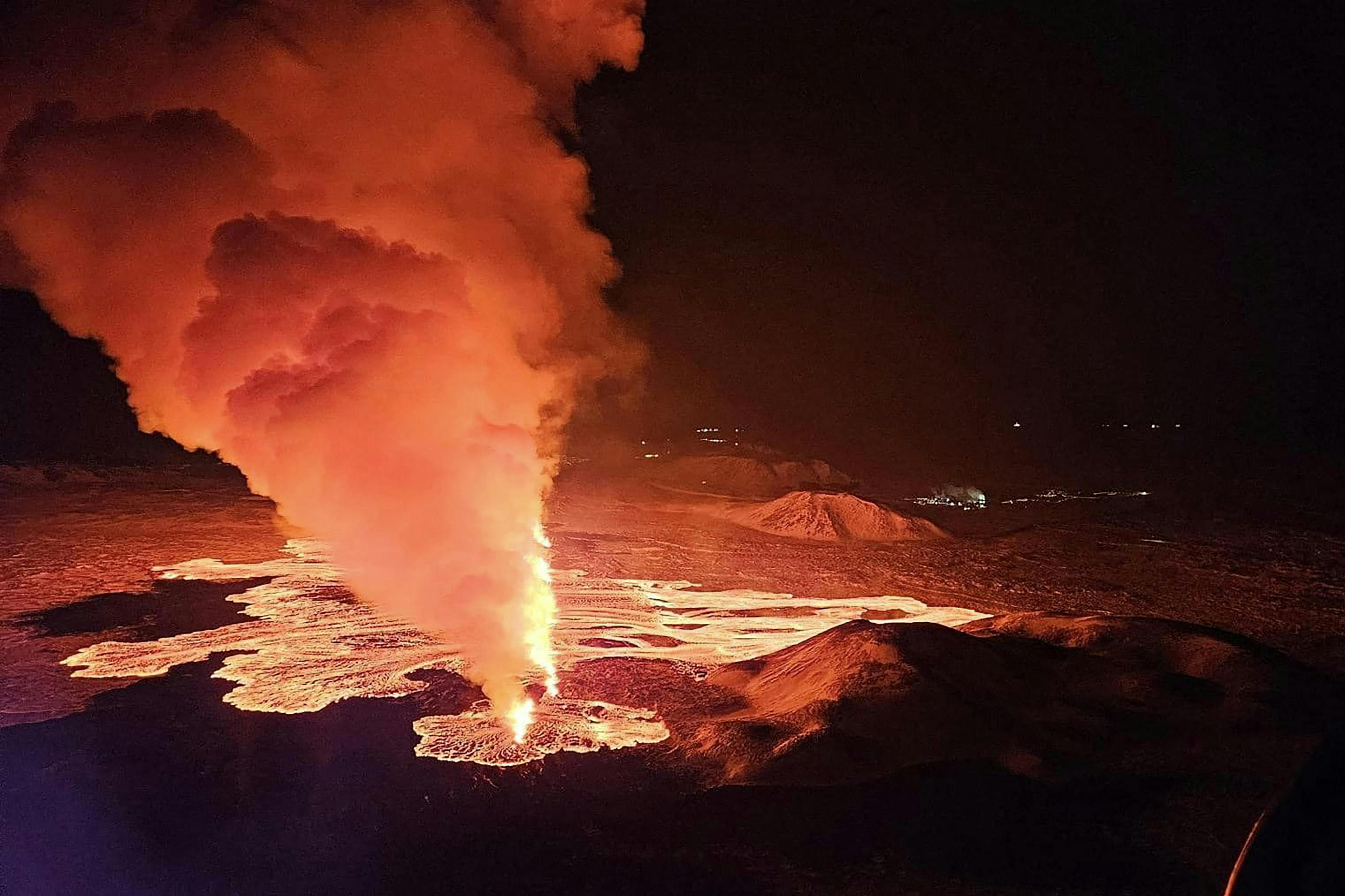 Billowing smoke and flowing lava are seen pouring out of a new fissure in this Icelandic Department of Civil Protection and Emergency Management , February 8, 2024, handout image during a new volcanic eruption on the outskirts of the evacuated town of Grindavik, western Iceland. A volcanic eruption started on the Reykjanes peninsula in southwestern Iceland on Thursday, the third to hit the area since December, authorities said. (Photo by Icelandic Department of Civil Protection and Emergency Management / AFP)