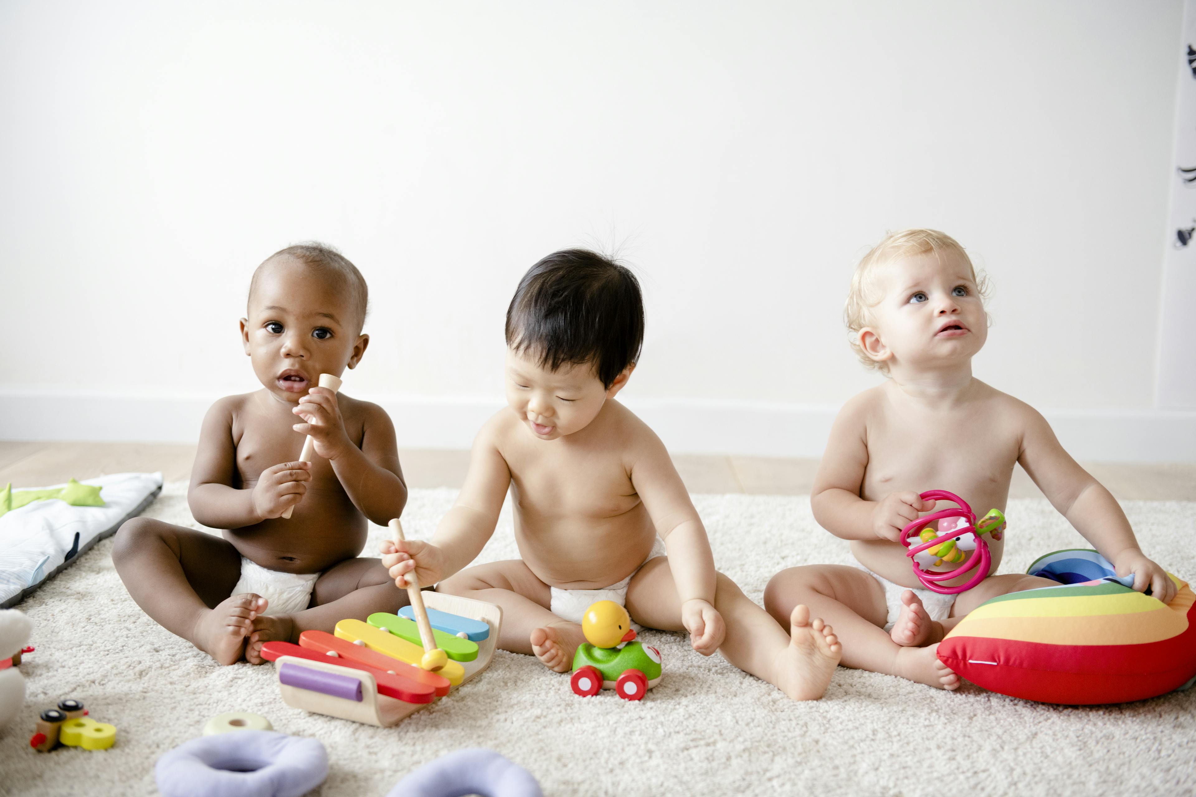 Babies playing together in a play room